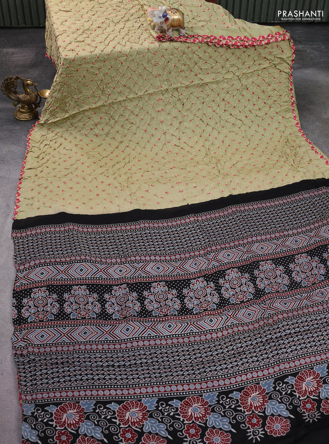 Modal silk saree pista green and black with allover bandhani butta prints and ajrakh printed pallu & Blouse