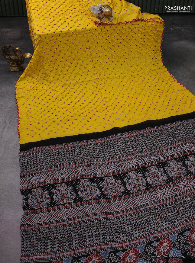 Modal silk saree yellow and black with allover bandhani butta prints and ajrakh printed pallu & Blouse