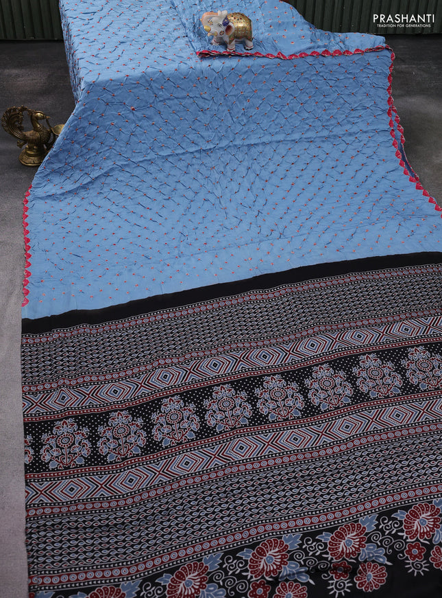 Modal silk saree pastel blue and black with allover bandhani butta prints and ajrakh printed pallu & Blouse