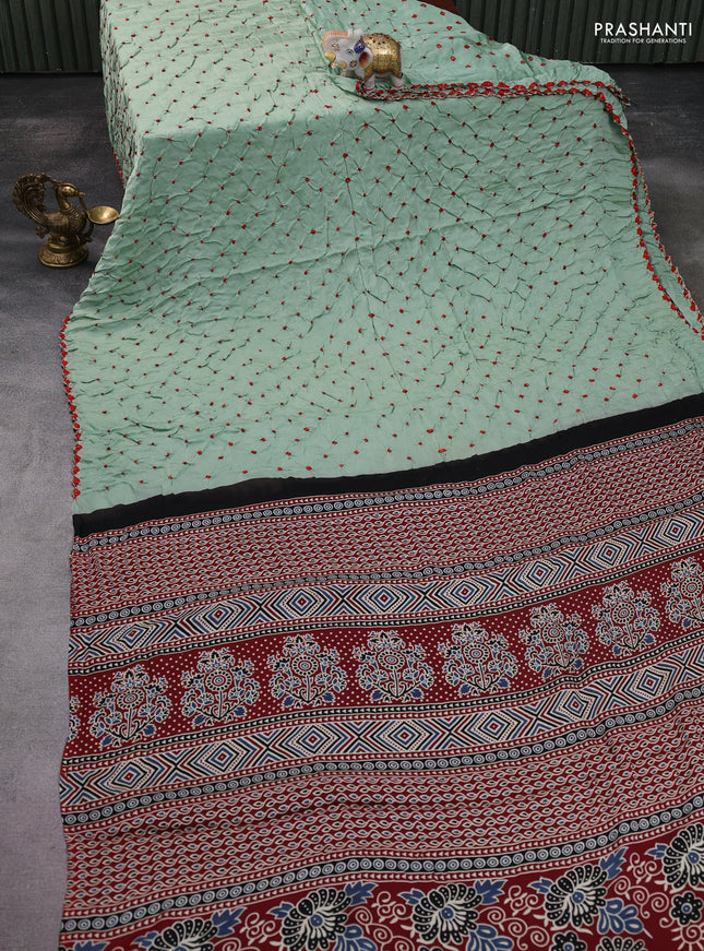 Modal silk saree pastel green and maroon with allover bandhani butta prints and ajrakh printed pallu & Blouse