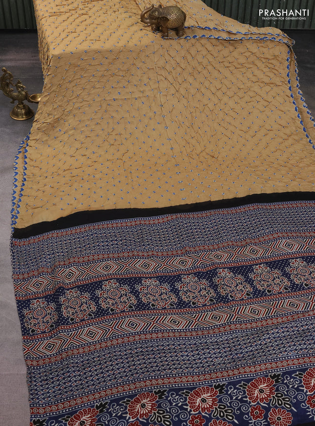 Modal silk saree sandal and peacock blue with allover bandhani butta prints and ajrakh printed pallu & Blouse