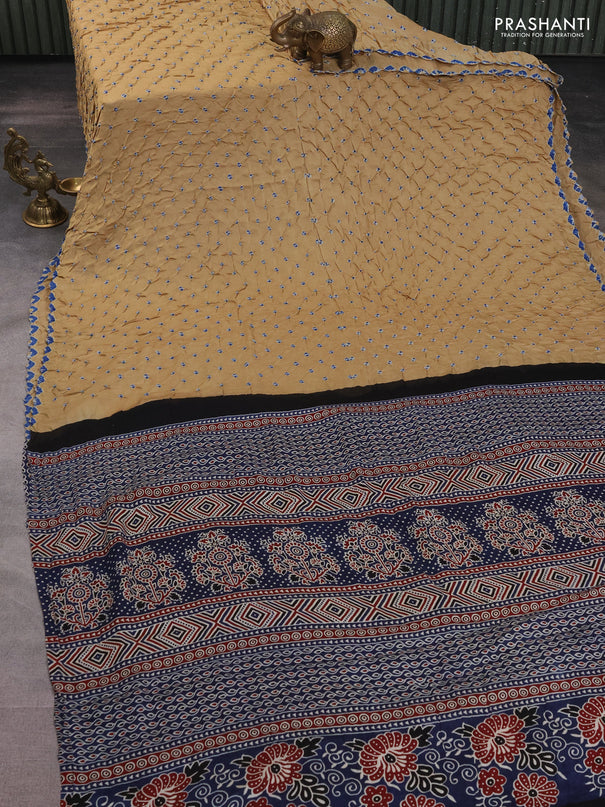 Modal silk saree sandal and peacock blue with allover bandhani butta prints and ajrakh printed pallu & Blouse