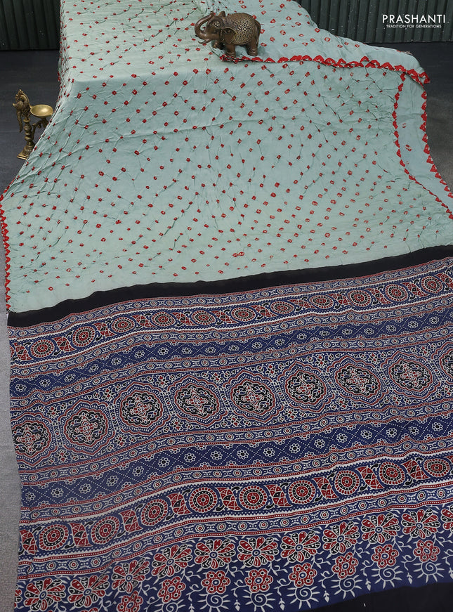 Modal silk saree pastel green and peacock blue with allover bandhani butta prints and ajrakh printed pallu & Blouse