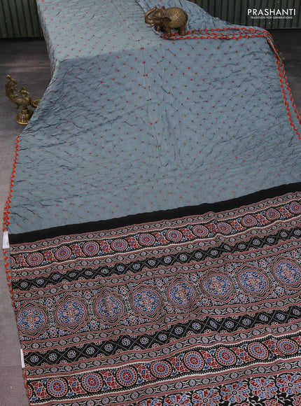 Modal silk saree pastel blue and black with allover bandhani butta prints and ajrakh printed pallu & Blouse