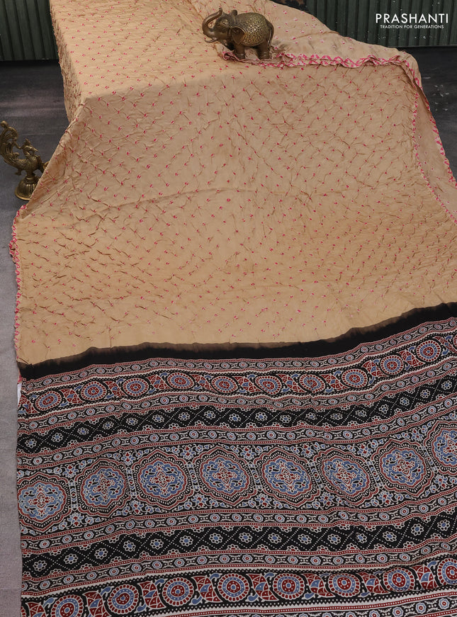 Modal silk saree sandal and black with allover bandhani butta prints and ajrakh printed pallu & Blouse