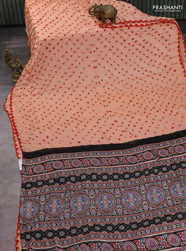 Modal silk saree peach orange and black with allover bandhani butta prints and ajrakh printed pallu & Blouse