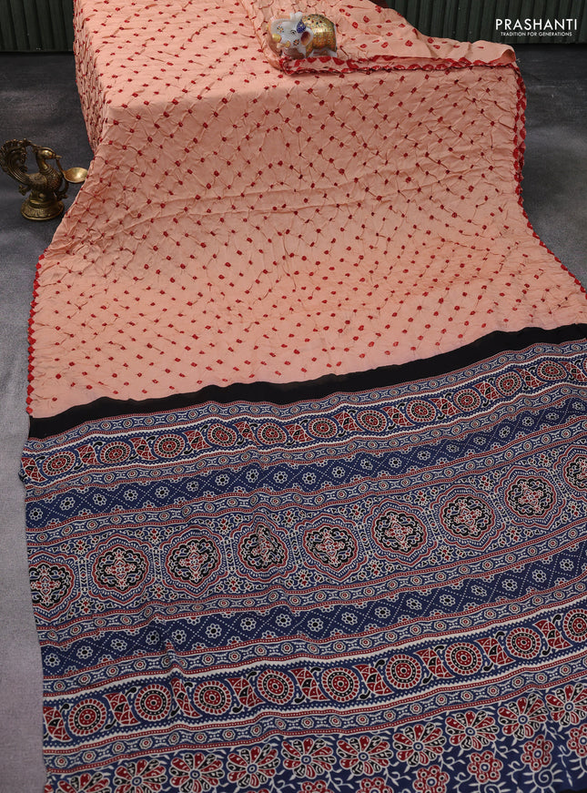 Modal silk saree peach orange and blue with allover bandhani butta prints and ajrakh printed pallu & Blouse