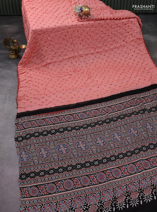 Modal silk saree peach orange and black with allover bandhani butta prints and ajrakh printed pallu & Blouse