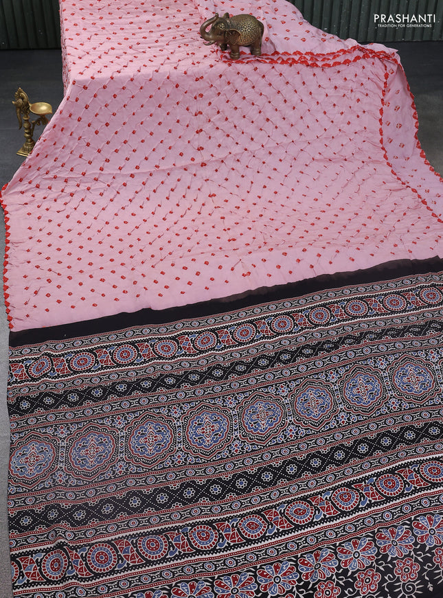 Modal silk saree peach pink and black with allover bandhani butta prints and ajrakh printed pallu & Blouse