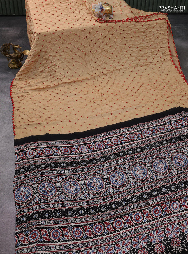 Modal silk saree sandal and black with allover bandhani butta prints and ajrakh printed pallu & Blouse