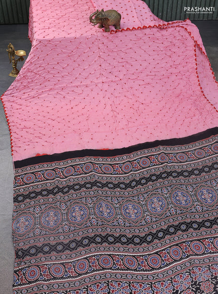 Modal silk saree peach pink and black with allover bandhani butta prints and ajrakh printed pallu & Blouse