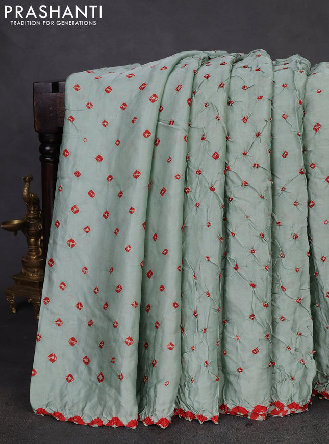 Modal silk saree pastel green and black with allover bandhani butta prints and ajrakh printed pallu & Blouse