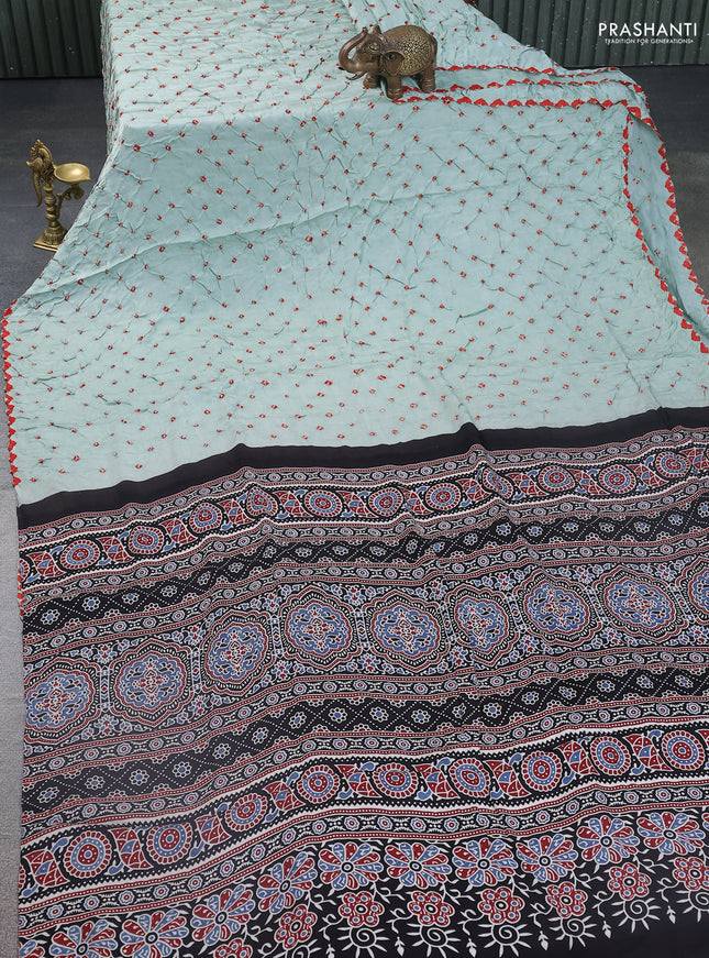 Modal silk saree pastel green and black with allover bandhani butta prints and ajrakh printed pallu & Blouse