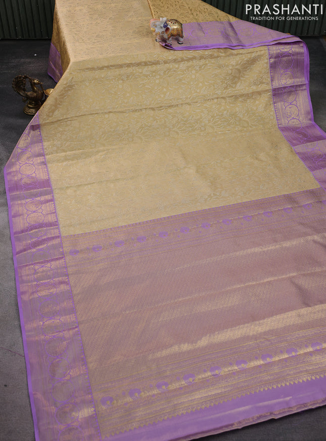 Kanchipuram silk saree sandal and lavender with allover zari woven brocade weaves and zari woven border