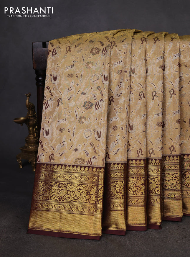 Kanchipuram tissue silk saree sandal and deep maroon with allover zari woven brocade weaves and zari woven border