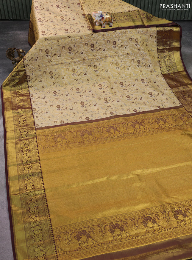 Kanchipuram tissue silk saree sandal and deep maroon with allover zari woven brocade weaves and zari woven border