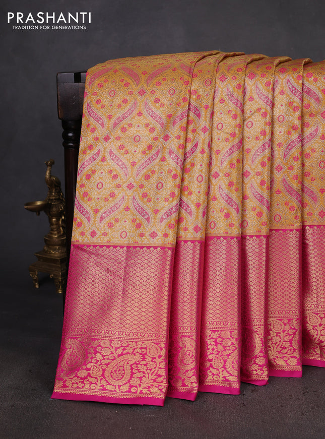 Kanchipuram tissue silk saree mustard yellow and pink with allover zari woven brocade weaves and zari woven border