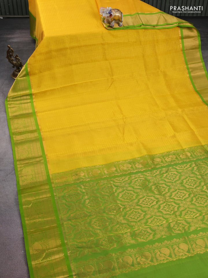 Kuppadam silk cotton saree yellow and green with allover lakshadeepam weaves and temple design zari woven border
