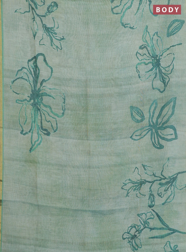 Linen cotton saree teal green with allover prints and zari woven piping border