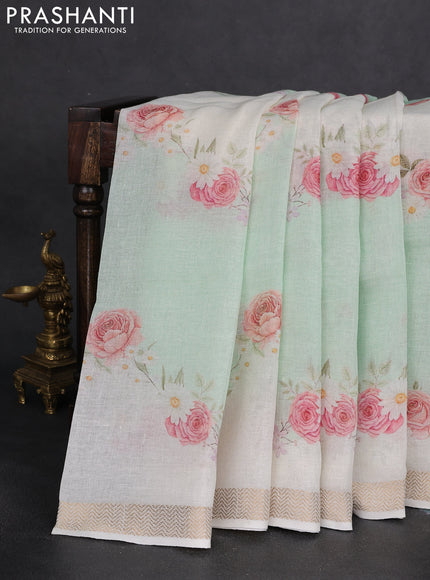 Pure linen saree teal green and cream with allover flower prints and zari woven border
