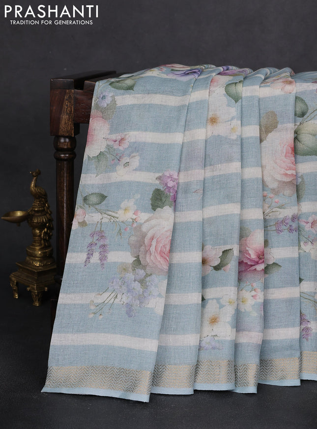 Pure linen saree teal blue and off white with allover flower prints and zari woven border