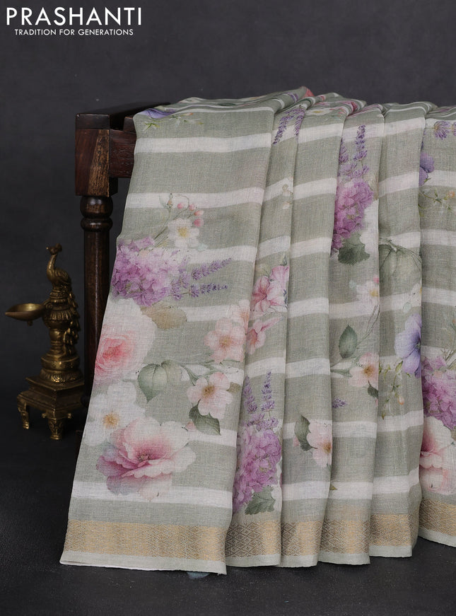 Pure linen saree pista green and off white with allover flower prints and zari woven border