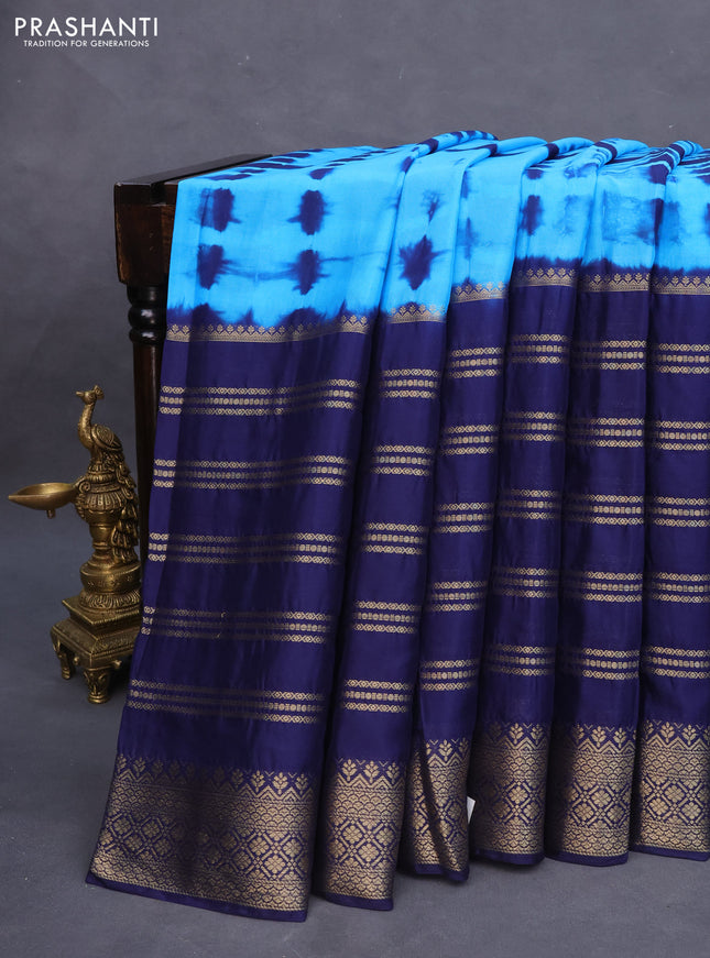 Semi crepe saree cs blue and blue with allover tie & dye prints and long zari woven border