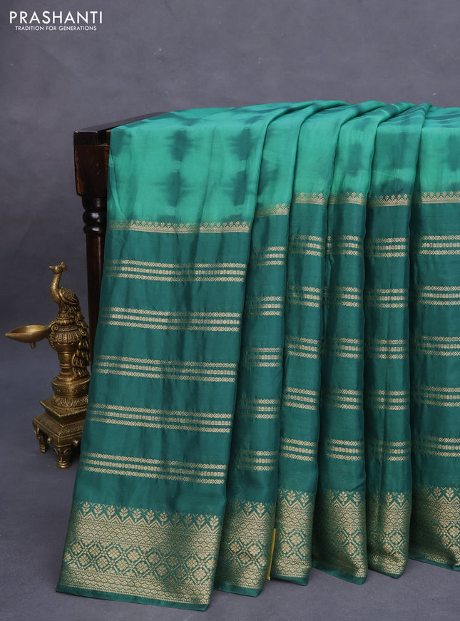 Semi crepe saree green with allover tie & dye prints and long zari woven border