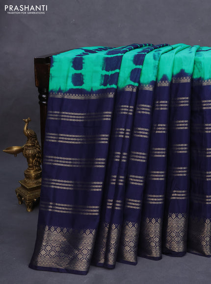 Semi crepe saree teal green and navy blue with allover tie & dye prints and long zari woven border