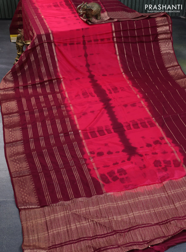 Semi crepe saree reddish pink and maroon with allover tie & dye prints and long zari woven border