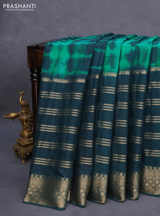 Semi crepe saree teal green and peacock green with allover tie & dye prints and long zari woven border