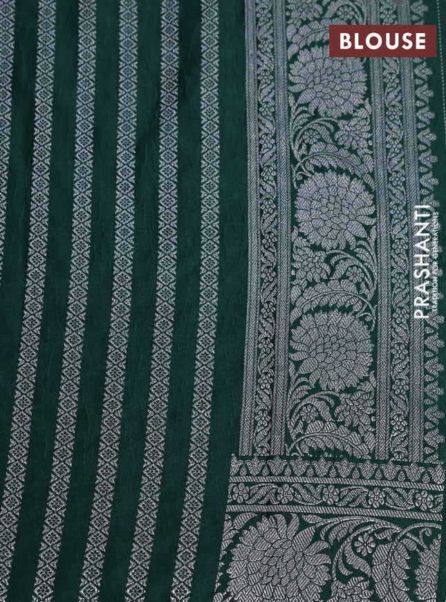 Banarasi crush crepe saree dark green with plain body and silver zari woven floral border
