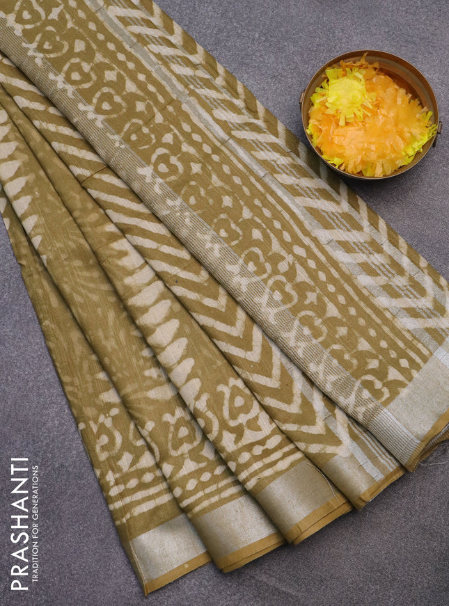 Linen cotton saree elaichi green and beige with allover prints and silver zari woven border