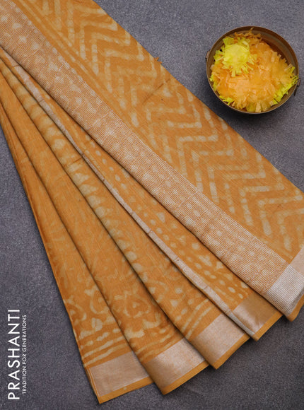 Linen cotton saree mustard yellow with dabu prints and silver zari woven border