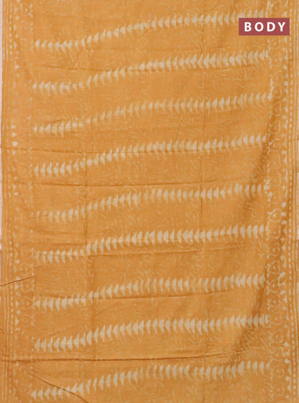 Linen cotton saree mustard yellow with dabu prints and silver zari woven border