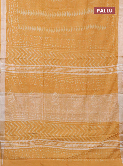 Linen cotton saree mustard yellow with dabu prints and silver zari woven border