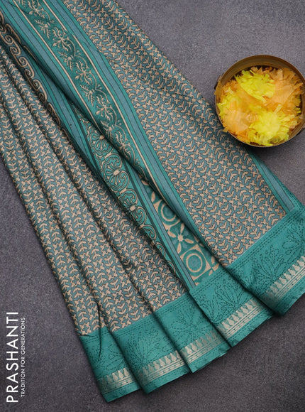 Muslin silk saree teal shade with allover prints and zari woven border