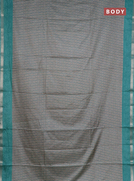 Muslin silk saree teal shade with allover prints and zari woven border
