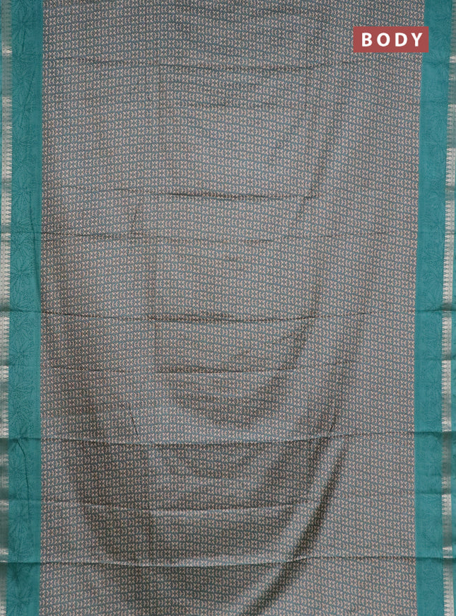 Muslin silk saree teal shade with allover prints and zari woven border