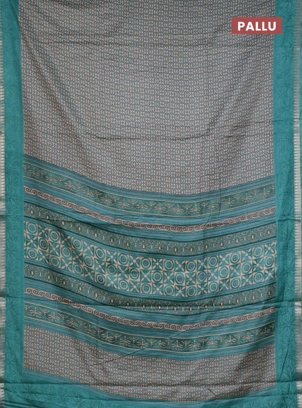 Muslin silk saree teal shade with allover prints and zari woven border