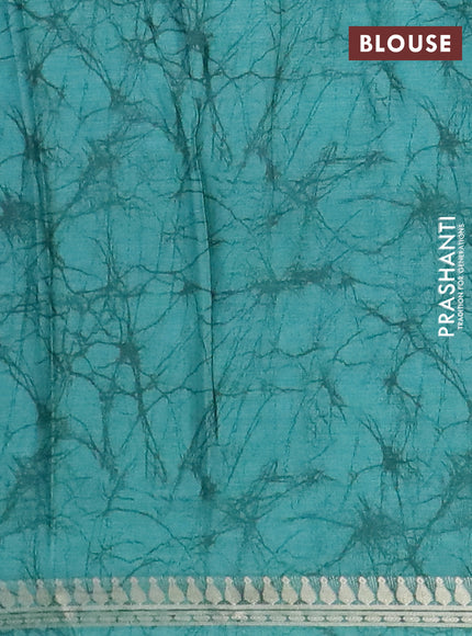 Muslin silk saree teal shade with allover prints and zari woven border