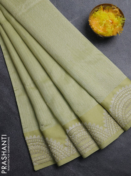 Jute silk saree pista green with embroidery buttas and embroidery border