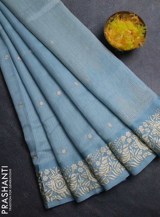 Jute silk saree pastel blue with embroidery buttas and parsi embroidery border