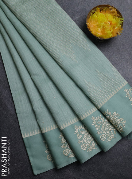 Jute silk saree pastel green with embroidery buttas and floral embroidery butta border