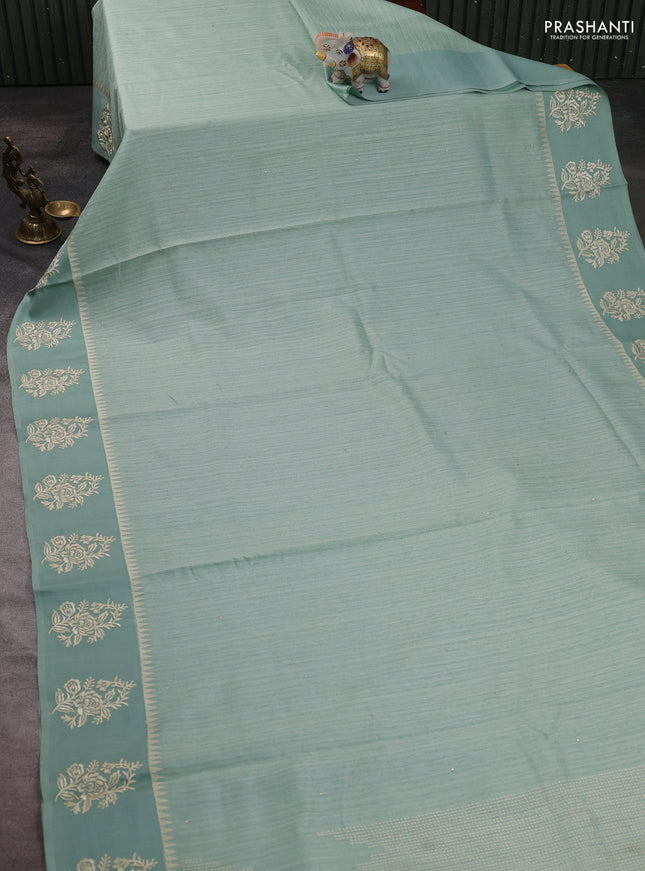 Jute silk saree pastel green with embroidery buttas and floral embroidery butta border