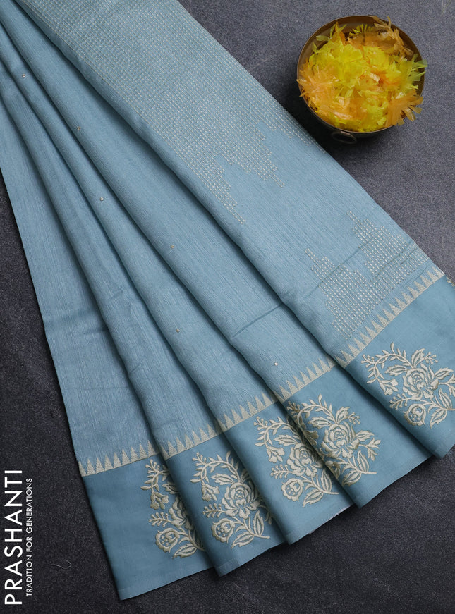 Jute silk saree pastel blue with embroidery buttas and floral embroidery butta border