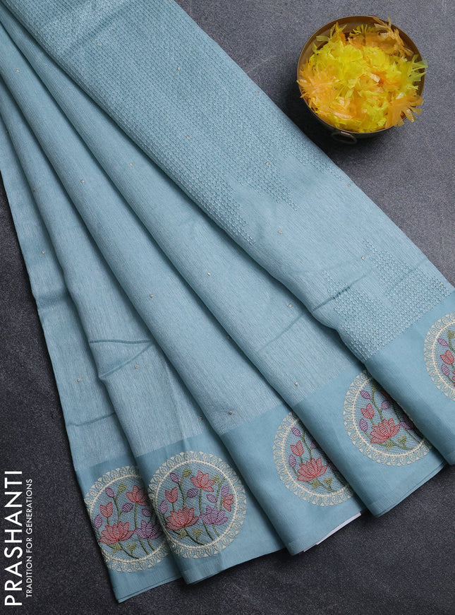 Jute silk saree pastel blue with embroidery buttas and floral embroidery butta border