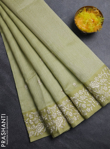 Jute silk saree pista green with embroidery buttas and embroidery border