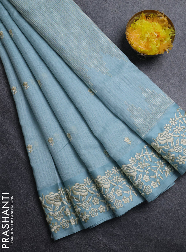 Jute silk saree pastel blue with embroidery buttas and embroidery border