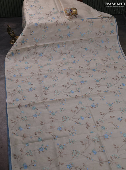 Kota silk saree beige and pastel blue with allover embroidery work and crocia lace border